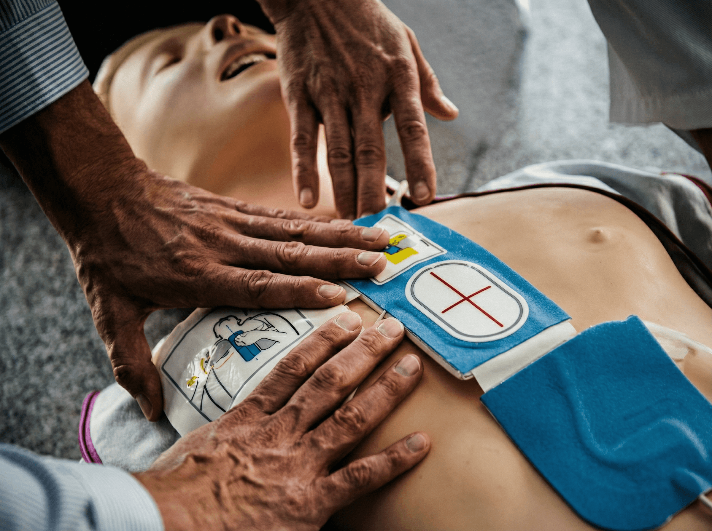 Adult performing CPR on child