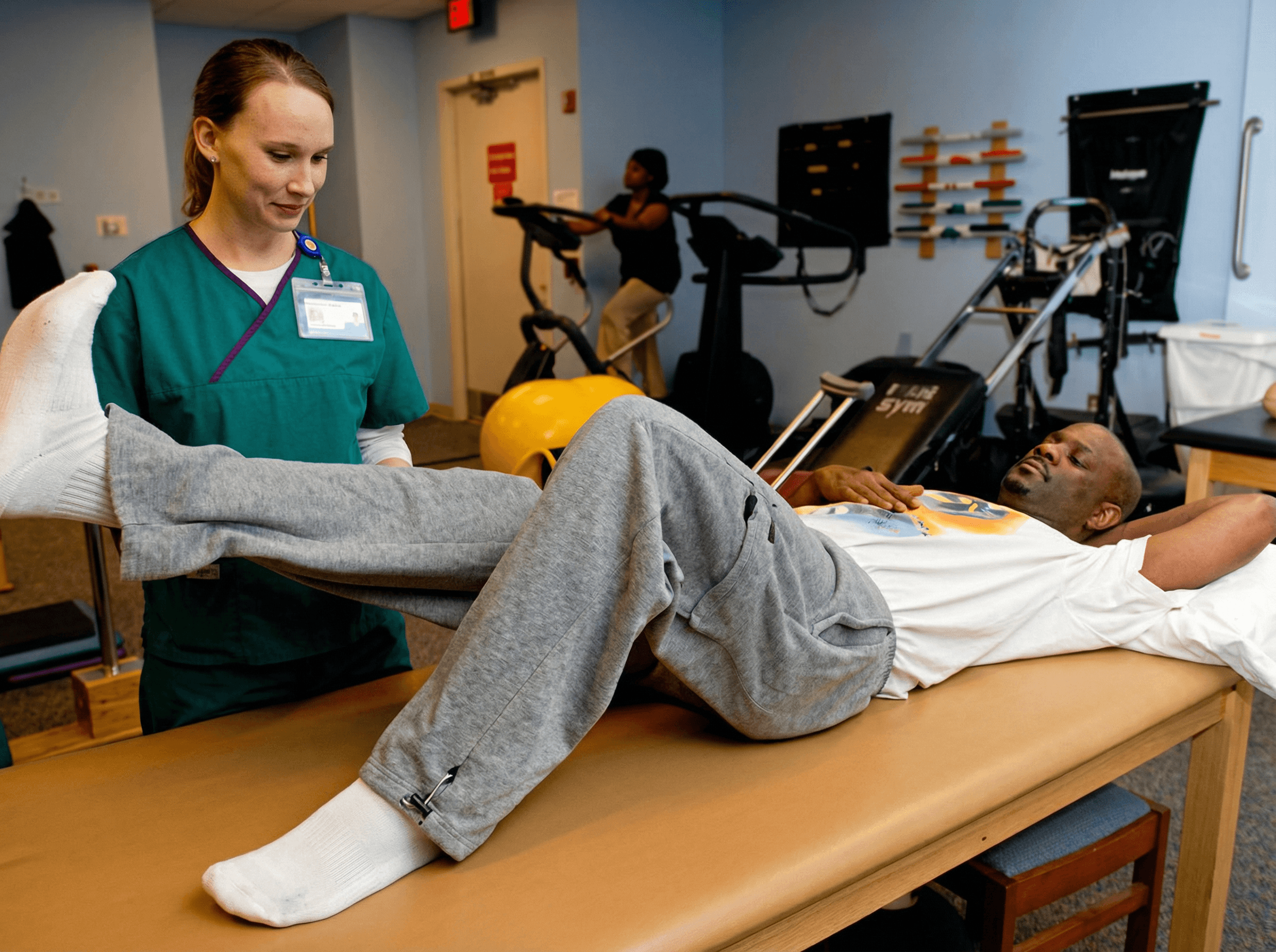 Nurse assisting patient with rehabilitation